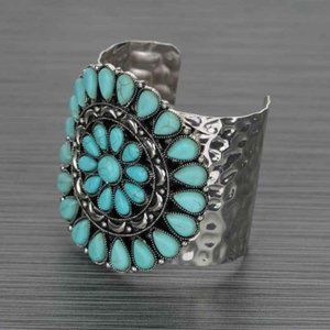 a squash blossom cuff bracelet with turquoise.